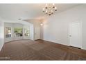 Bright living room featuring fresh neutral paint, new carpet and wood-look flooring and ample natural light at 20814 N Dries Rd, Maricopa, AZ 85138