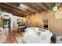 Stylish living room with brick accent wall, wood beamed ceiling, and neutral-toned furniture at 3032 N 32Nd St # 61, Phoenix, AZ 85018