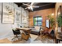 Inviting home office features a brick accent wall, cozy seating area, and natural light at 3032 N 32Nd St # 61, Phoenix, AZ 85018