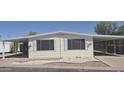 Inviting home featuring a covered carport and low-maintenance front yard landscaping at 3104 E Broadway Rd # 268, Mesa, AZ 85204
