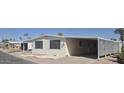 Well-kept property with a covered carport and mature palm trees offering shade and curb appeal at 3104 E Broadway Rd # 268, Mesa, AZ 85204