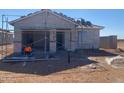 Home construction in progress showing exterior walls and window openings on a desert lot in a new neighborhood at 32296 N Pony Express Rd, San Tan Valley, AZ 85143