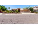 Inviting single-story home with a lush front yard and a spacious driveway at 3535 E Brookwood Ct, Phoenix, AZ 85048