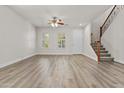 Bright and airy living room with wood floors, ceiling fan, and shuttered windows at 3575 E Gary Way, Gilbert, AZ 85234