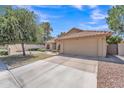 Single-story home with a tile roof, two-car garage, desert landscaping and a spacious driveway on a sunny day at 3882 S Hawthorn Dr, Chandler, AZ 85248