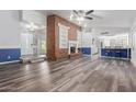Spacious living room with wood flooring, brick fireplace, and an open concept design that flows into the kitchen at 428 S Sunnyvale --, Mesa, AZ 85206