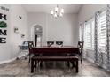 Well-lit dining room with modern chandelier and window, perfect for gatherings and Gathering meals at 5354 E Ellis St, Mesa, AZ 85205