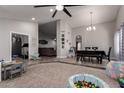 Spacious living area with modern fan, seamlessly flowing into the dining area with carpet and tile flooring at 5354 E Ellis St, Mesa, AZ 85205