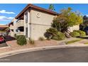 Exterior view of a condominium featuring desert landscaping and a private staircase to the second floor entrance at 7557 N Dreamy Draw Dr # 154, Phoenix, AZ 85020