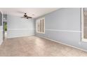A room featuring a ceiling fan, tiled floors, and natural light from window with shutters at 9142 W Pontiac Dr, Peoria, AZ 85382