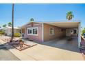 Charming home featuring covered parking and a well-maintained desert-style landscaped front yard at 9302 E Broadway Rd # 122, Mesa, AZ 85208