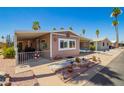 Charming home featuring covered parking and a well-maintained desert-style landscaped front yard at 9302 E Broadway Rd # 122, Mesa, AZ 85208