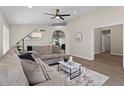 Spacious living room featuring wood-look floors, neutral paint, modern furnishings, and a ceiling fan at 1030 S Brentwood Ct, Chandler, AZ 85286