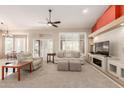 Spacious living room featuring a fireplace, comfortable seating, and ample natural light at 15073 W Piccadilly Rd, Goodyear, AZ 85395