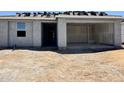 Unfinished home exterior shows front entrance and two-car garage at 15789 W Beryl Ave, Waddell, AZ 85355
