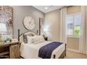 Cozy bedroom with a decorative clock, wood accents, and natural light at 16342 W Jackson St, Goodyear, AZ 85338