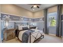 Stylized bedroom featuring themed decor, natural light, and a ceiling fan at 16342 W Jackson St, Goodyear, AZ 85338