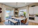 Bright dining room with modern lighting and a sliding glass door to the patio at 16342 W Jackson St, Goodyear, AZ 85338