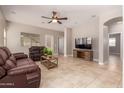 Inviting living room with tile floors and a cozy media cabinet at 1688 W Corriente Dr, San Tan Valley, AZ 85144