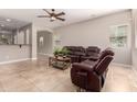 Spacious living room with tile flooring, ceiling fan, and comfortable seating at 1688 W Corriente Dr, San Tan Valley, AZ 85144