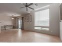 Spacious open-plan living room featuring tile flooring, neutral paint, and abundant natural light at 1851 W Vermont Ave, Phoenix, AZ 85015
