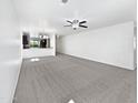 A view of a large and bright open living area with neutral carpet and seamless transition to the kitchen at 1953 W Stage Driver St, Apache Junction, AZ 85120