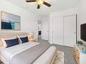 Comfortable main bedroom with soft carpet, ceiling fan, ensuite bathroom, and ample closet space at 1953 W Stage Driver St, Apache Junction, AZ 85120