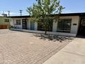 Beautiful single-story home with a neatly landscaped yard and brick paver driveway at 2325 E Osborn Rd, Phoenix, AZ 85016