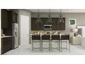 A modern kitchen featuring dark cabinets, stainless steel appliances, and a stylish island at 25169 N 177Th Dr, Surprise, AZ 85387