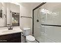 Well-lit bathroom with a glass-enclosed shower, dark accents, and modern fixtures for a clean aesthetic at 3326 N 31St St, Mesa, AZ 85213