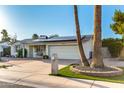 Charming home featuring well-maintained landscaping, solar panels, and a brick driveway at 4046 E Crocus Dr, Phoenix, AZ 85032