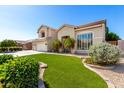 Charming home featuring a well-manicured lawn, desert landscaping, and a tile roof at 4530 E Decatur St, Mesa, AZ 85205
