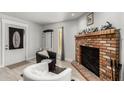 Bright living room with a brick fireplace and stylish seating at 505 S Ridge --, Mesa, AZ 85204