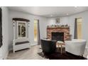 Bright living room with a brick fireplace and stylish seating at 505 S Ridge --, Mesa, AZ 85204