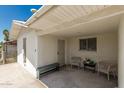 Covered patio area, featuring white walls, chairs and bench at 505 S Ridge --, Mesa, AZ 85204