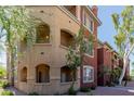 Exterior view of three-story condo building showing balconies, terraces, windows, and desert landscaping at 5401 E Van Buren St # 1088, Phoenix, AZ 85008
