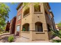 Exterior view of condo building showing balconies, terraces, windows, stucco siding, and desert landscaping at 5401 E Van Buren St # 1088, Phoenix, AZ 85008