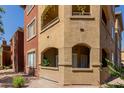 Exterior view of condo building showing terraces, balconies, stucco siding, windows, and desert landscaping at 5401 E Van Buren St # 1088, Phoenix, AZ 85008
