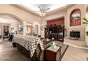 Open concept living room with fireplace, entertainment center, tile flooring, and high ceilings at 5534 W Riviera Dr, Glendale, AZ 85304