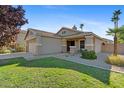 Inviting curb appeal with a charming front porch, desert landscaping, and a two-car garage at 7027 W Midway Ave, Glendale, AZ 85303