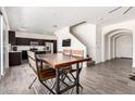 Open-concept dining area with modern table, seamlessly connected to kitchen and staircase at 820 E Constance Way, Phoenix, AZ 85042