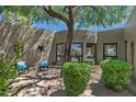 Private courtyard surrounded by the house with mature trees and outdoor seating area at 8306 E Buckskin Trl, Scottsdale, AZ 85255