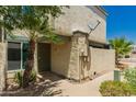 Exterior of condo with sand-colored stucco, front security door, sidewalk and palm trees at 9011 N 52Nd Ave, Glendale, AZ 85302