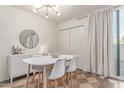 Dining room featuring contemporary chandelier, modern furniture, and seamless access to an outdoor balcony at 930 S Dobson Rd # 3, Mesa, AZ 85202