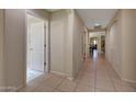 Inviting hallway featuring neutral walls, tiled floors, and archways for added elegance at 9926 W Gross Ave, Tolleson, AZ 85353