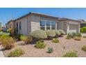 Landscaped front yard with desert plants and shrubs in a desert rock landscape at 10240 E Supernova Dr, Mesa, AZ 85212