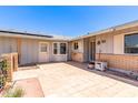 Enclosed patio with tile and brick accents with the home's siding and entry visible at 10651 W Saratoga Cir, Sun City, AZ 85351