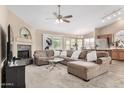 Inviting living room featuring a cozy fireplace, large sectional sofa, and open floor plan at 1330 W Butler Dr, Chandler, AZ 85224