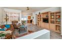 Cozy living room with hardwood floors, built-in shelving, and large windows at 17449 N Fairway Dr, Surprise, AZ 85374