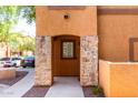 Inviting entrance of townhome featuring stone columns and address number 1165 at 1920 E Bell Rd # 1165, Phoenix, AZ 85022